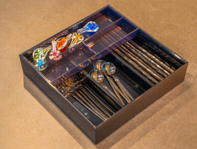 Luxury cutlery set at Bayside Villa Miyako Island with organized stainless steel utensils and colorful decorative accessories in elegant wooden box.
