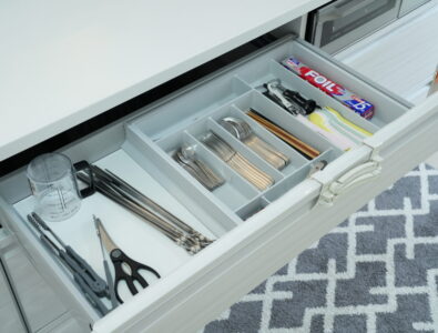 Well-organized kitchen drawer at Ocean Villa Tokunoshima with compartmentalized cutlery, utensils, and cooking accessories for guest convenience.