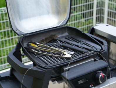Electric BBQ grill with grilling tools at Ocean Villa Tokunoshima featuring digital temperature display and outdoor cooking accessories.